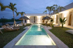 The outdoor pool area at night at Kavo Maison Surf & Yoga Camp
