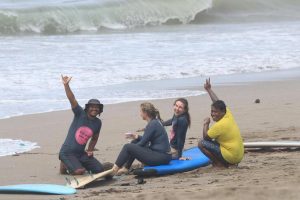 A group of people taking a surfing lesson at a beach