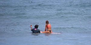 Two surfers waiting for the waves in the sea