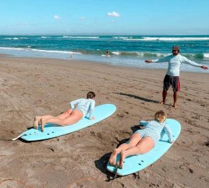 a surfing lesson or course for beginners at a beach
