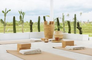 A minimalist and tropical outdoor yoga space located at Kavo Maison Surf & Yoga Camp