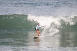 A woman is riding a wave on a surfboard