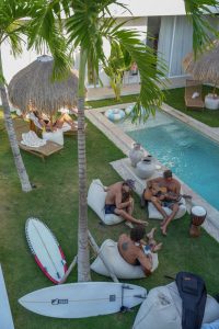 guests relaxing by the pool at Kavo Maison Surf & Yoga Camp