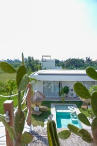 show the pool and courtyard area at the Kavo Maison Surf & Yoga Camp