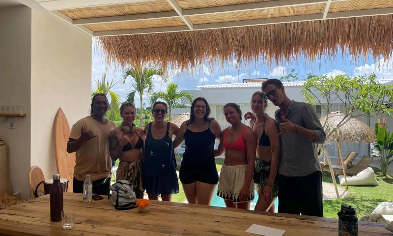 A group of people standing together and posing in the dining area at Kavo Maison